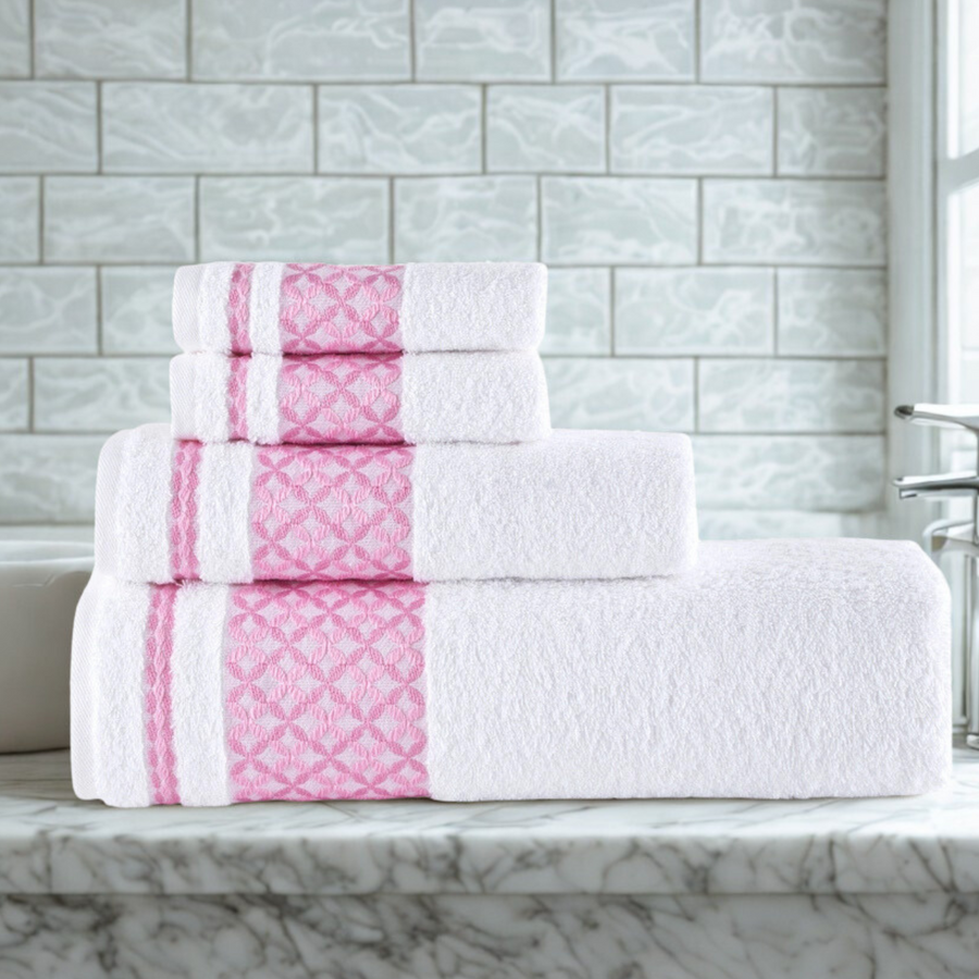 Stack of white towels with pink stripes on a marble countertop against a tiled wall.