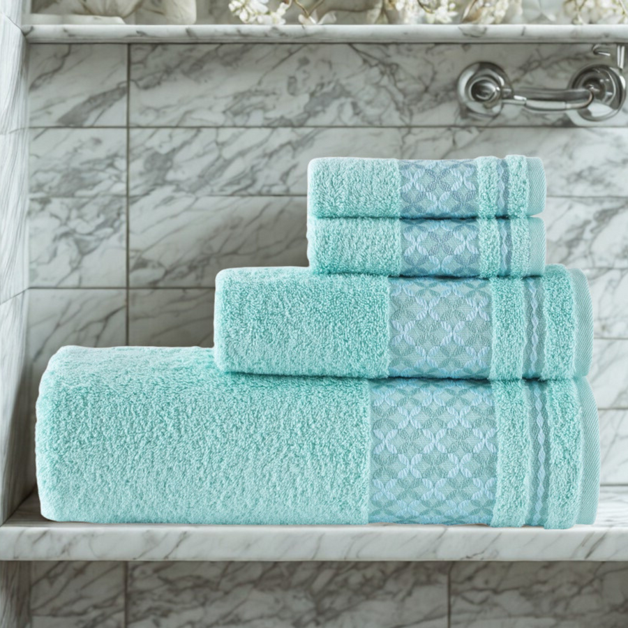 Set of teal towels on a marble shelf